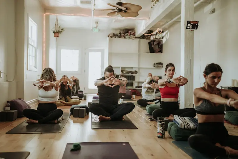 Seated eagle-arms stretch during a restorative class