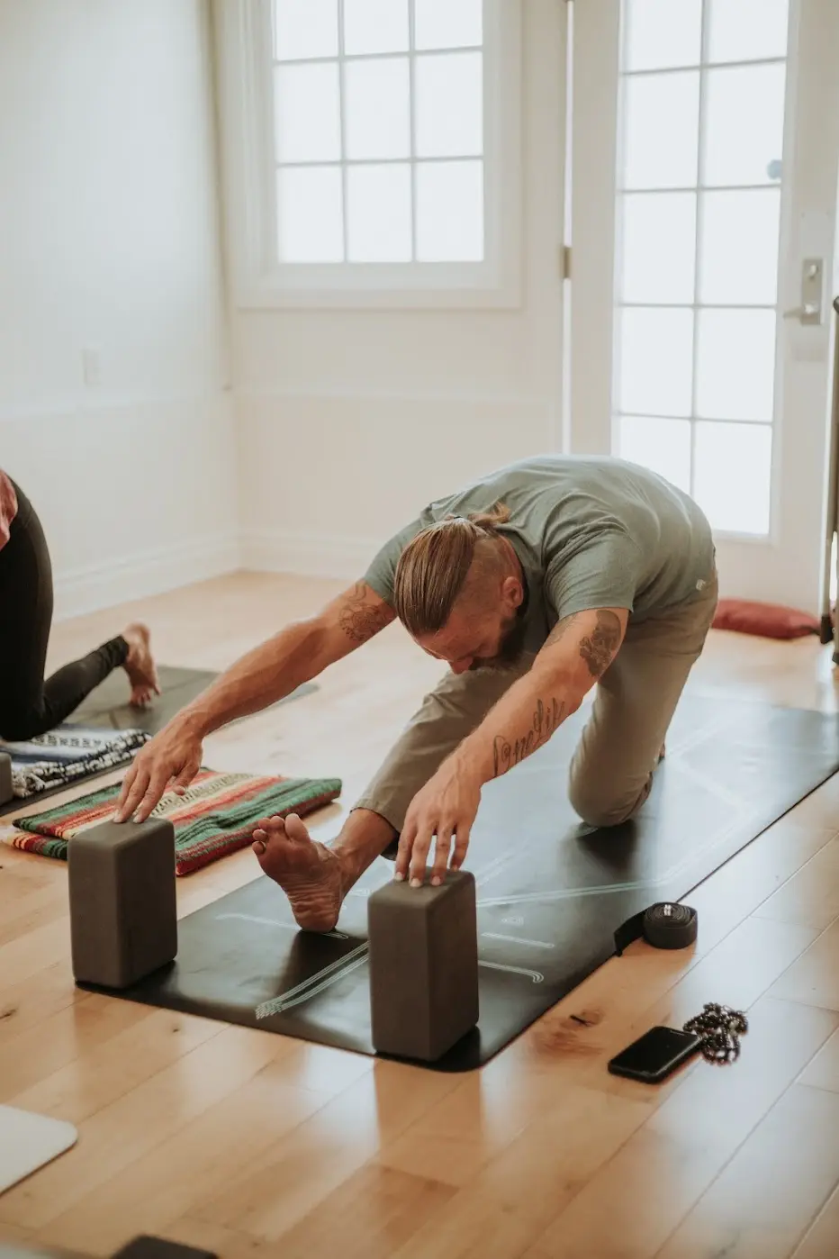 Yoga student stretching with blocks